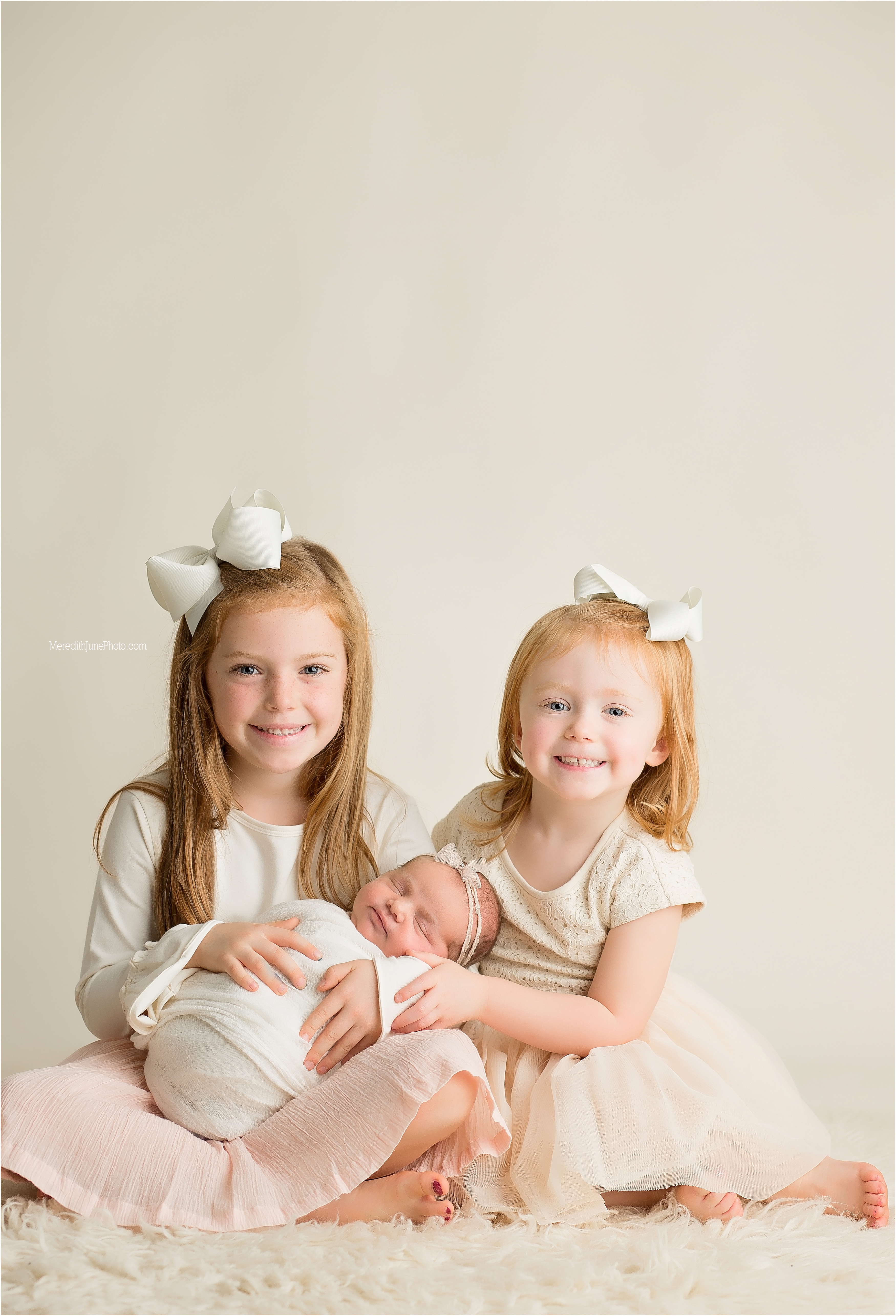 newborn with sisters