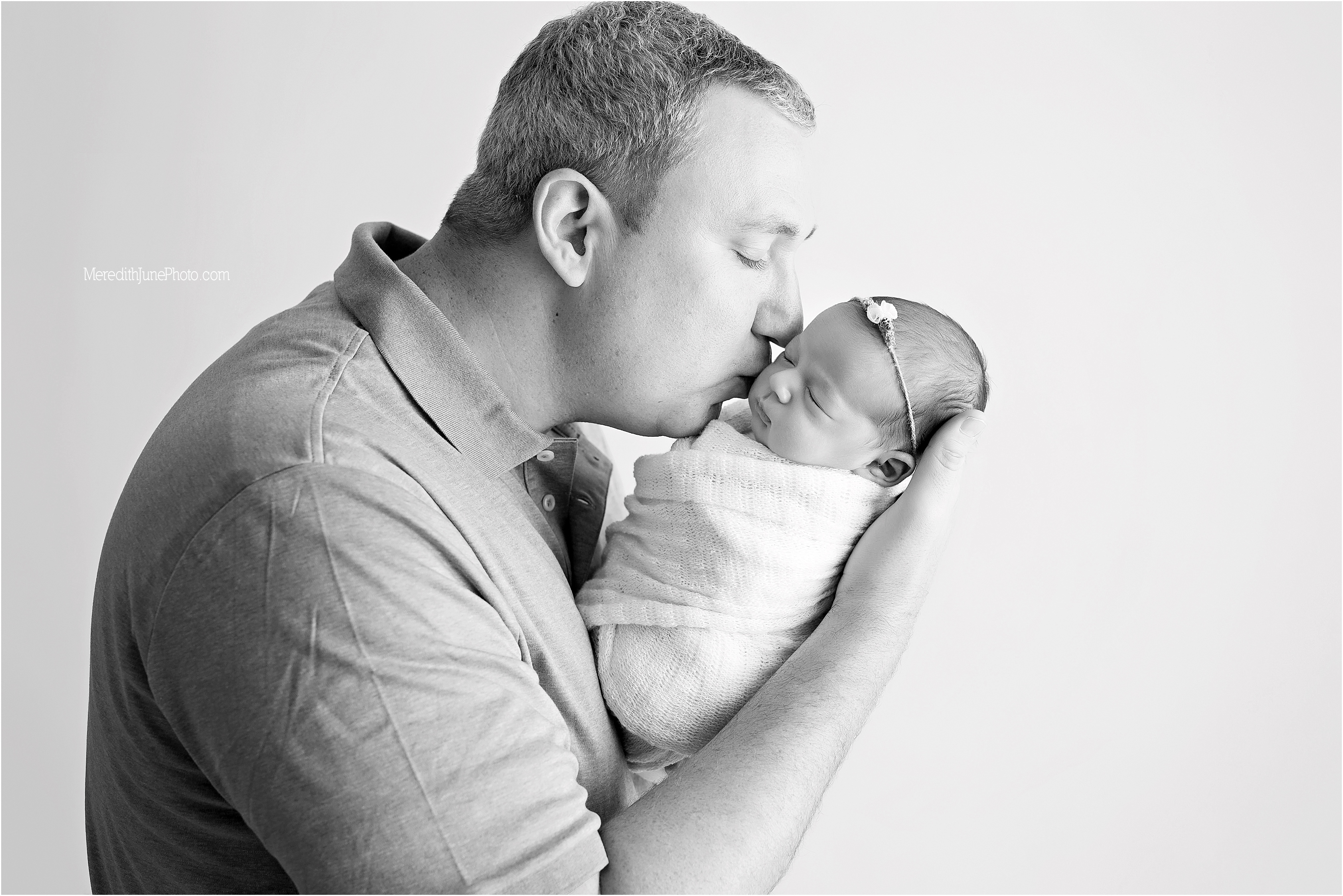 Baby girl with dad during newborn photo session