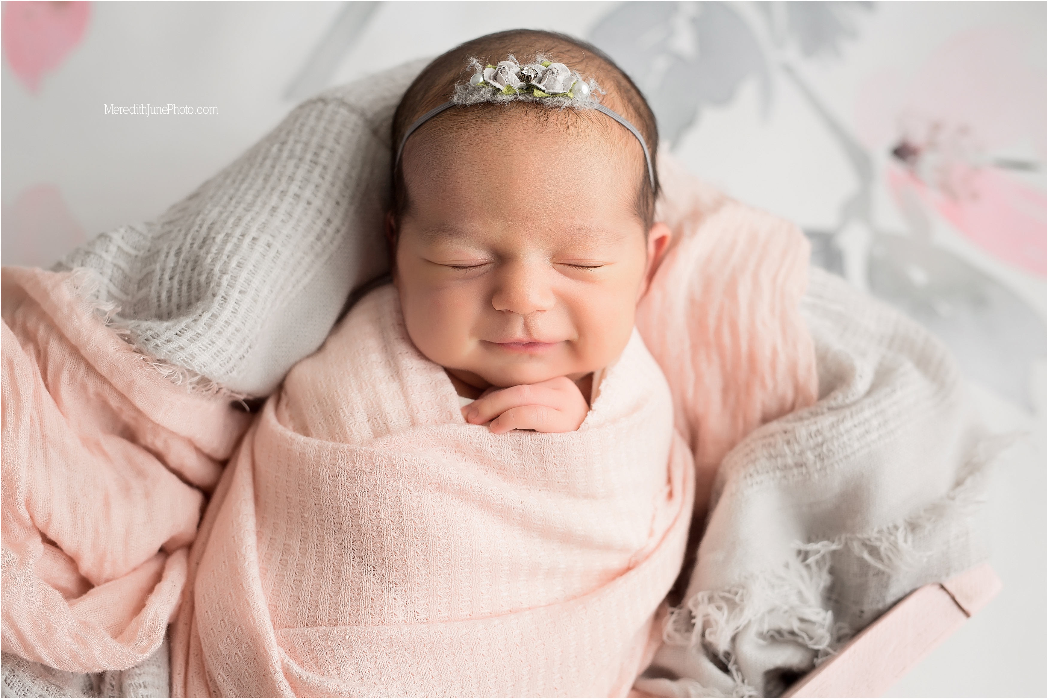 Baby Danielle smiling at the end of newborn session