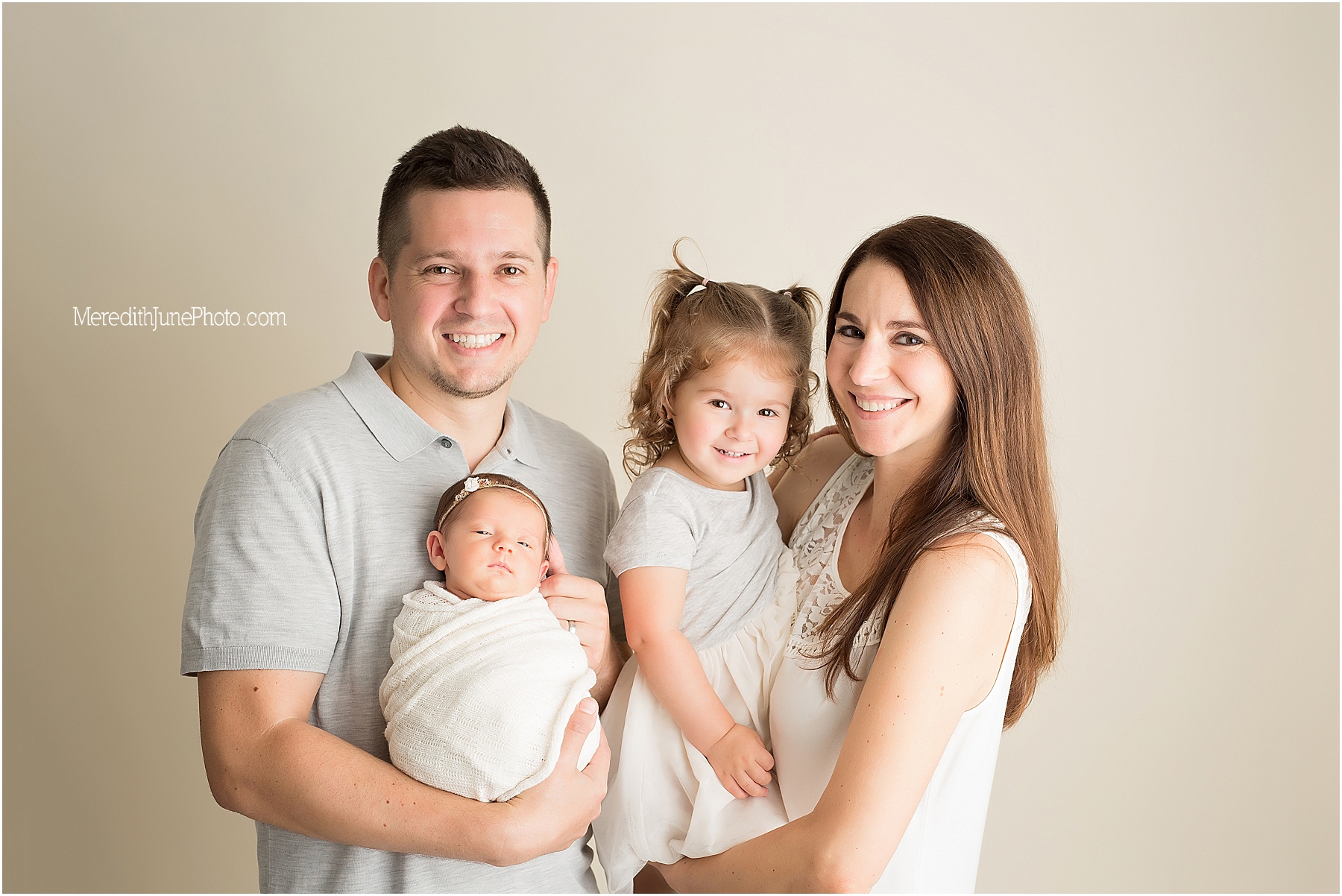 Newborn with family and siblings during newborn session