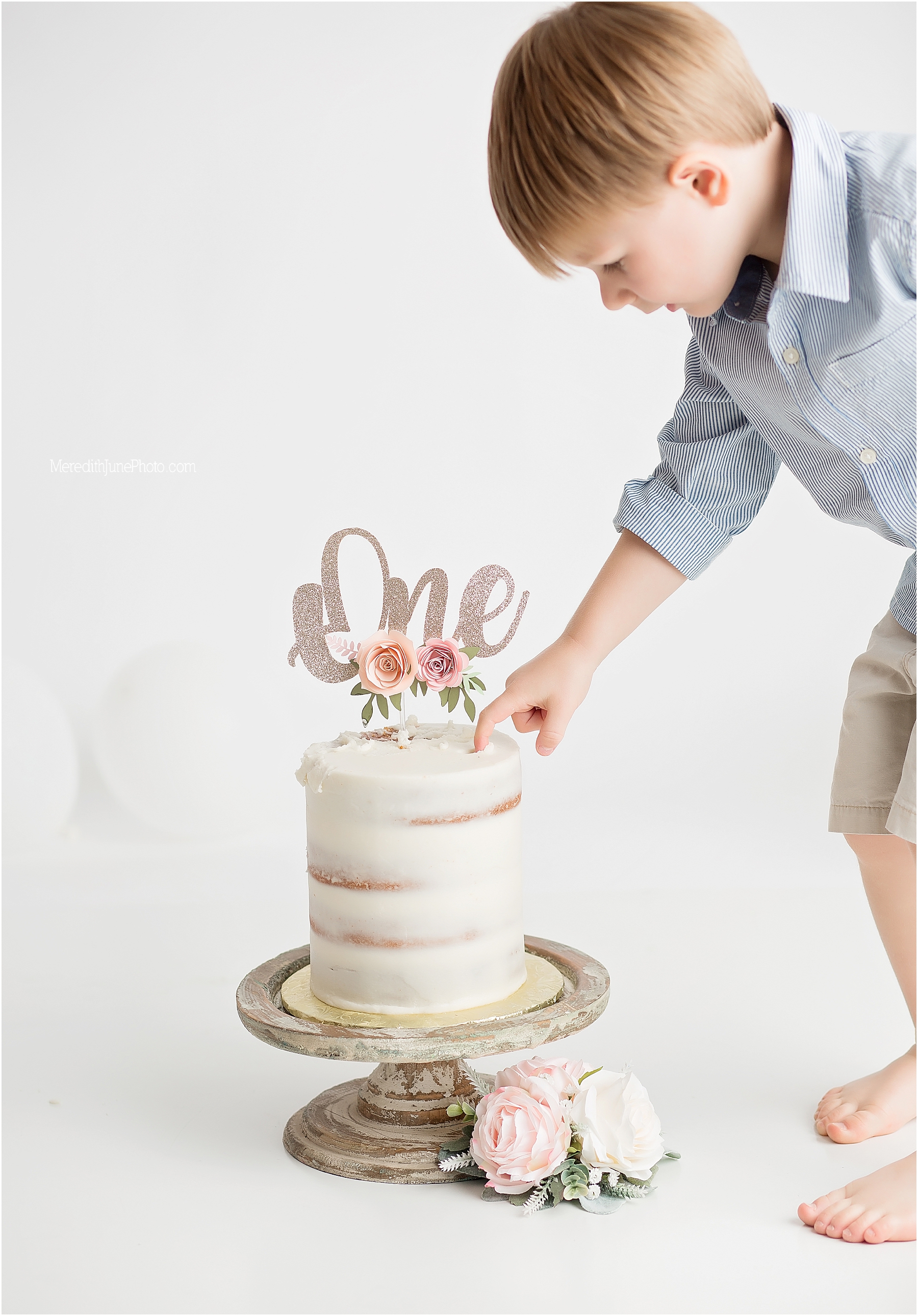 all white cake smash session for baby girl with family