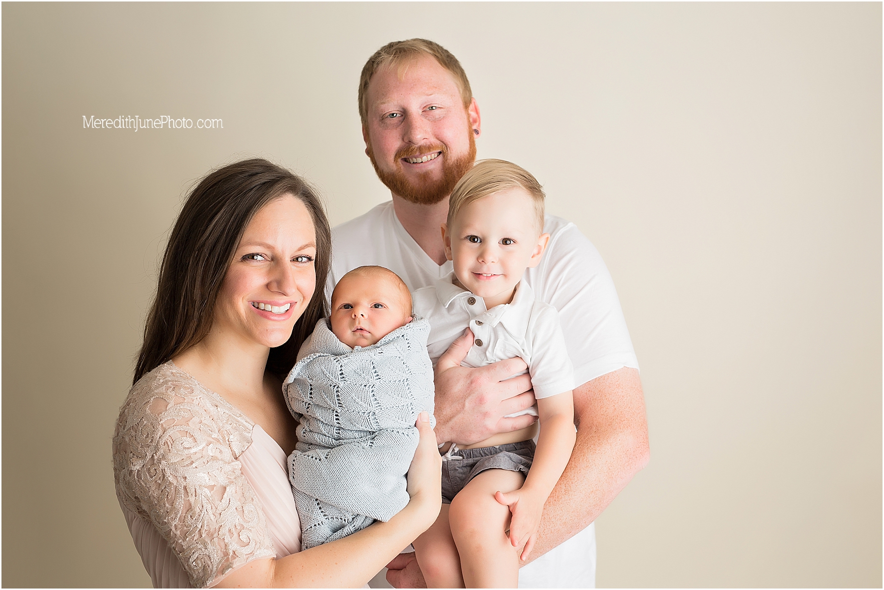 baby boy with family during newborn session 