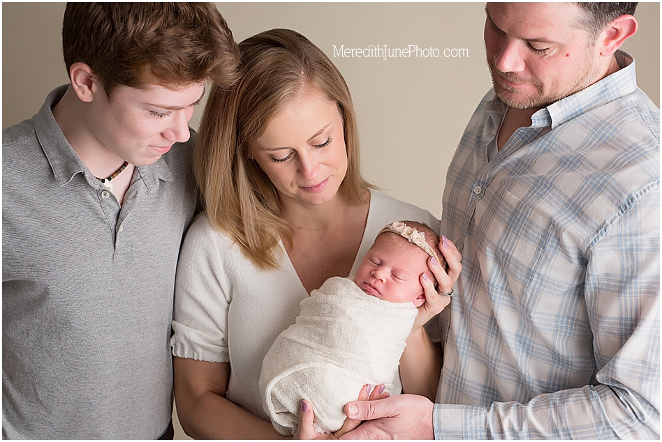 newborn with family during newborn portraits 