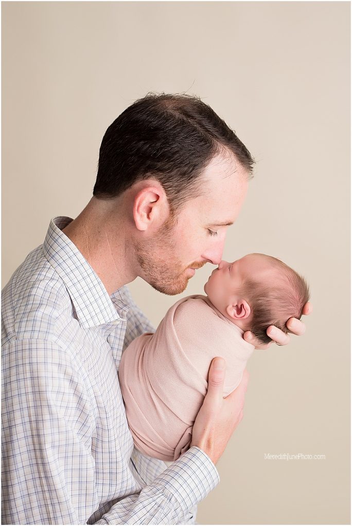 Newborn baby girl photos with dad at MJP studios in Charlotte NC