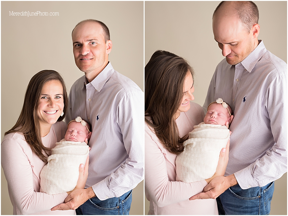 Newborn baby girl posing with parents 
