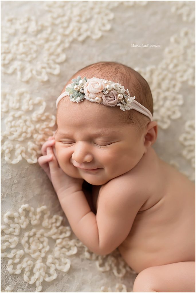Newborn baby girl against lace photos by MJP