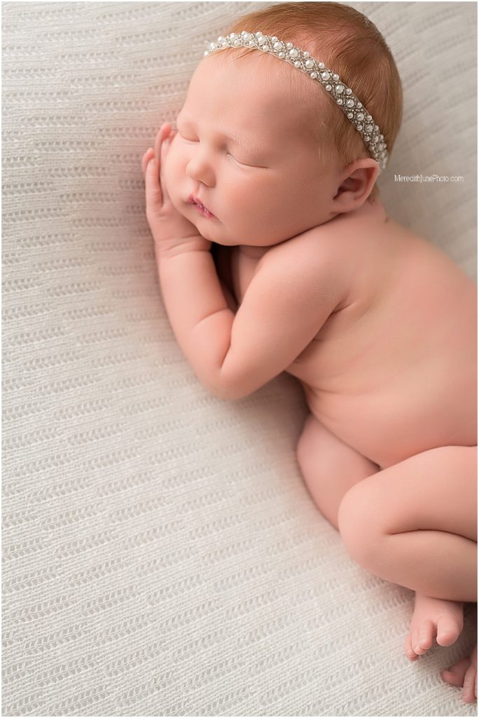 Newborn baby girl on white by Charlotte photographer 