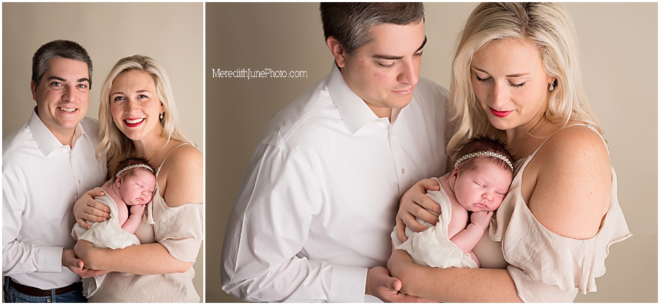Newborn baby with parents in Charlotte photography studio