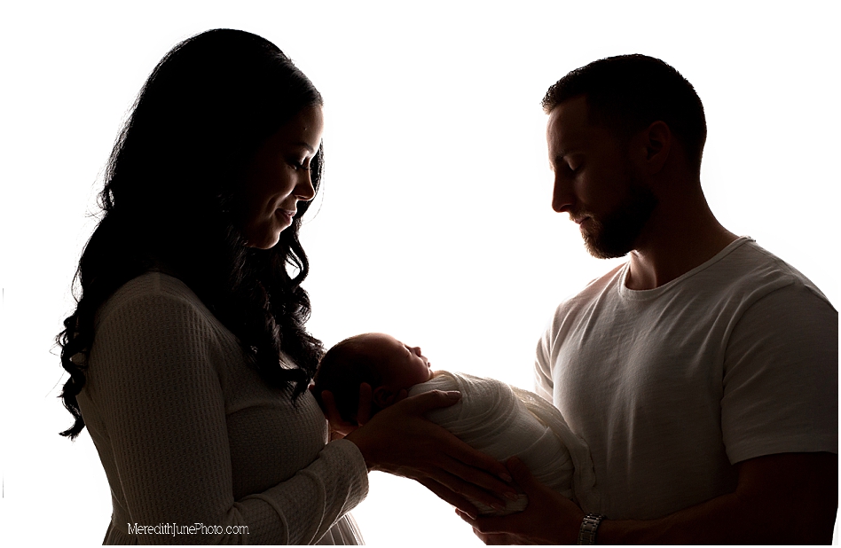 newborn baby boy pictures with parents in photography studio