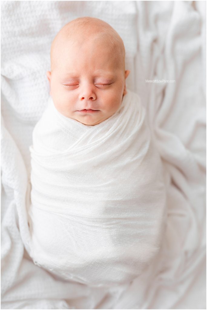bright white newborn pictures of baby boy by Meredith June Photography 